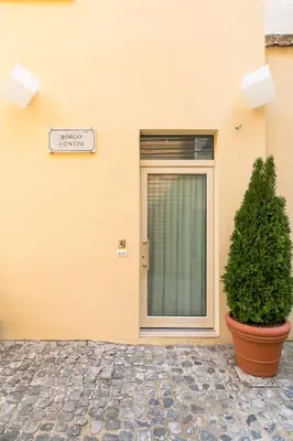 a sign on a building with a door and a plant at Demetra Eco Guest House in Rome