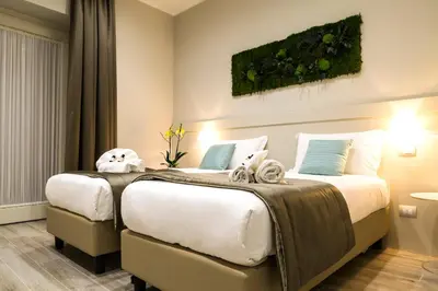 two beds in a hotel room with stuffed animals on them at Demetra Eco Guest House in Rome