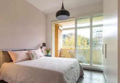 a bedroom with a bed and a large window at AventinoHome in Rome