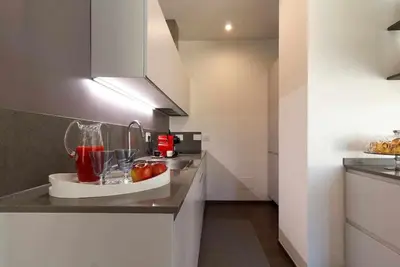 a kitchen with a counter with a bowl of fruit on it at AventinoHome in Rome
