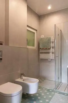a bathroom with a toilet and a sink and a shower at AventinoHome in Rome