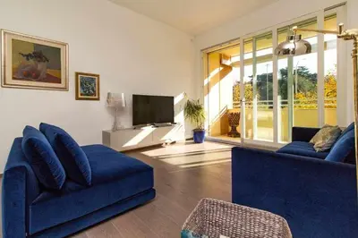 a living room with two blue couches and a television at AventinoHome in Rome