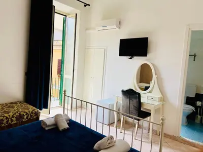 a bedroom with a bed and a mirror and a tv at Hotel Pisa in Rome