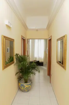 a room with a counter with a lamp and a mirror at Hotel Pisa in Rome