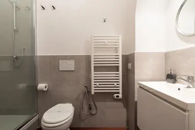 a bathroom with a toilet and a glass shower at Majestic Trastevere in Rome