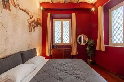 a bedroom with a bed with two hands on the wall at Majestic Trastevere in Rome