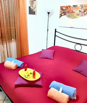 a pair of blue towels on a red wall at Comfortable studio in Rome 40.2 m² with wifi in Rome
