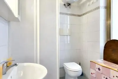 a white bathroom with a sink and a toilet at Comfortable studio in Rome 40.2 m² with wifi in Rome