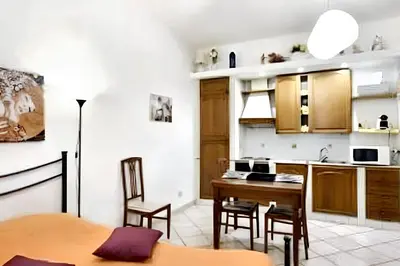 a kitchen with a table and chairs in a room at Comfortable studio in Rome 40.2 m² with wifi in Rome