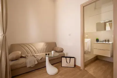a living room with a couch and a mirror at Domus Veneto Rome in Rome