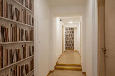 a hallway with a wall of books at Domus Veneto Rome in Rome