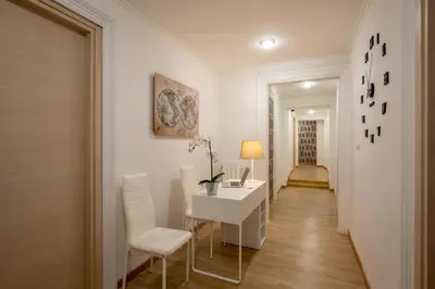 a hallway with a desk and chairs in a room at Domus Veneto Rome in Rome