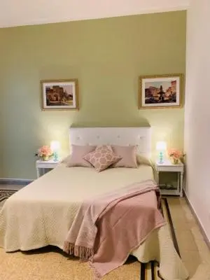 a bedroom with a large bed with two night stands at Mama Roma Domus in Rome