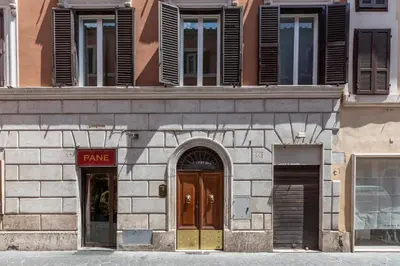 a stone building with two doors and a store at Louly Spanish Steps in Rome