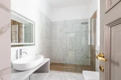 a white bathroom with a sink and a shower at Louly Spanish Steps in Rome