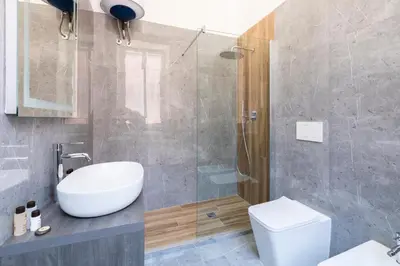 a bathroom with a shower and a sink and a toilet at Louly Spanish Steps in Rome