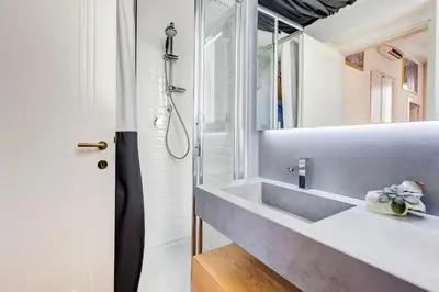 a bathroom with a sink and a mirror at Colosseum Terrace Apartment in Rome