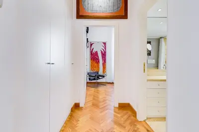 a hallway with white walls and a painting on the wall at Colosseum Terrace Apartment in Rome