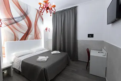 a bedroom with a bed with two towels on it at Rubino Guest House in Rome