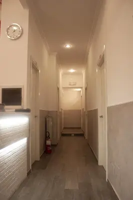 an empty hallway with a clock on the wall at Rubino Guest House in Rome