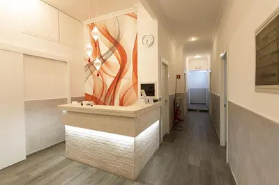 a bathroom with a counter with a painting on the wall at Rubino Guest House in Rome