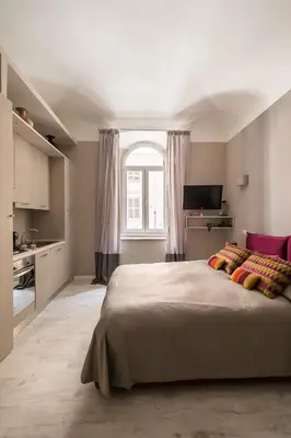 a bedroom with a large bed and a window at Apt.Prati L.T. (Vatican and center) in Rome