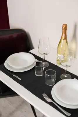 a table with plates and glasses and a bottle of wine at Apt.Prati L.T. (Vatican and center) in Rome
