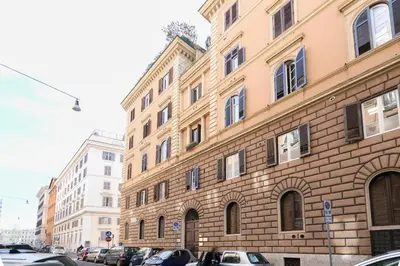 a large brick building with cars parked in front of it at Apt.Prati L.T. (Vatican and center) in Rome