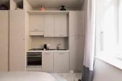 a small kitchen with white cabinets and a sink at Apt.Prati L.T. (Vatican and center) in Rome