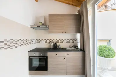a kitchen with wooden cabinets and a sink at Royal Piazza di Spagna in Rome