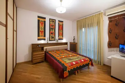 a bedroom with a bed and a desk and a window at Eucalyptus Resort - Roma San Paolo - in Rome