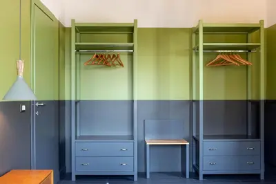 a walk in closet with green and blue at MODO Rooms & Suite Rome in Rome