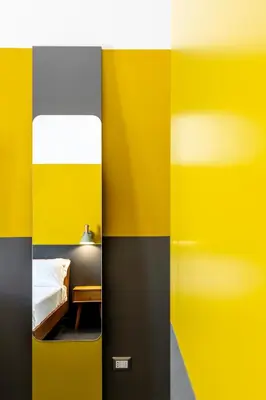 a bedroom with yellow and black walls and a bed at MODO Rooms & Suite Rome in Rome