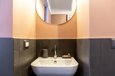 a bathroom with a white sink and a mirror at MODO Rooms & Suite Rome in Rome