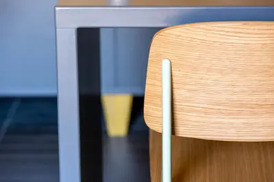a wooden chair sitting next to a table at MODO Rooms & Suite Rome in Rome