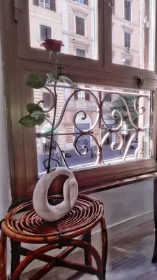 a vase with a flower on top of a window at Novaroma by Local Domus in Rome