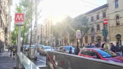 a busy city street with cars parked on the street at Novaroma by Local Domus in Rome