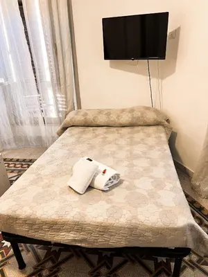 a bedroom with a bed with a tv on the wall at Novaroma by Local Domus in Rome