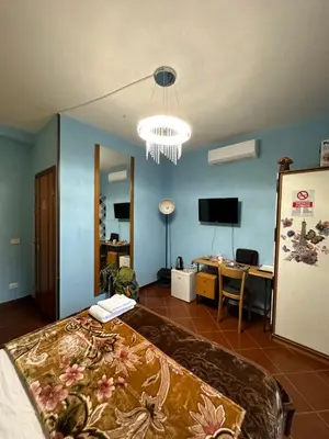 a bedroom with a bed and a room with a desk at Signor Suite Colosseo in Rome