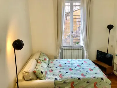 a room with a couch and a bed in front of a window at Sant’Onofrio - Trastevere Vatican apartment Roma in Rome