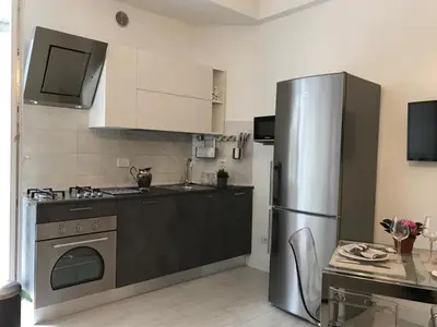 a kitchen with a stainless steel refrigerator and a stove at CASA DONATELLO con TERRAZZO in Rome