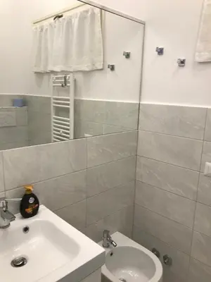 a bathroom with a sink and a toilet and a mirror at CASA DONATELLO con TERRAZZO in Rome
