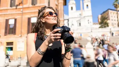 a woman taking a picture with a camera at Nido del Gambero - Your Suite with View in Rome