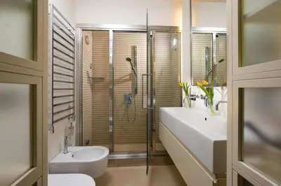 a bathroom with a shower and a toilet and a sink at Nido del Gambero - Your Suite with View in Rome