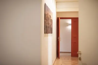 an empty hallway with a door and a picture on the wall at BEIGE ET BLE' GuestHouse in Rome