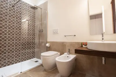 a bathroom with a toilet and a sink and a shower at BEIGE ET BLE' GuestHouse in Rome