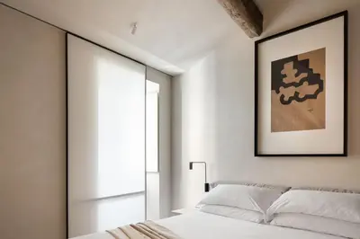 a bedroom with a bed and a large window at Hotel Scenario in Rome