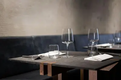 a table with wine glasses and napkins on it at Hotel Scenario in Rome