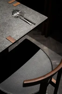 a black table with a fork and spoon and a chair at Hotel Scenario in Rome