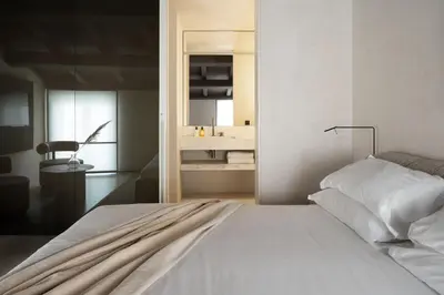 a bedroom with a white bed and a mirror at Hotel Scenario in Rome